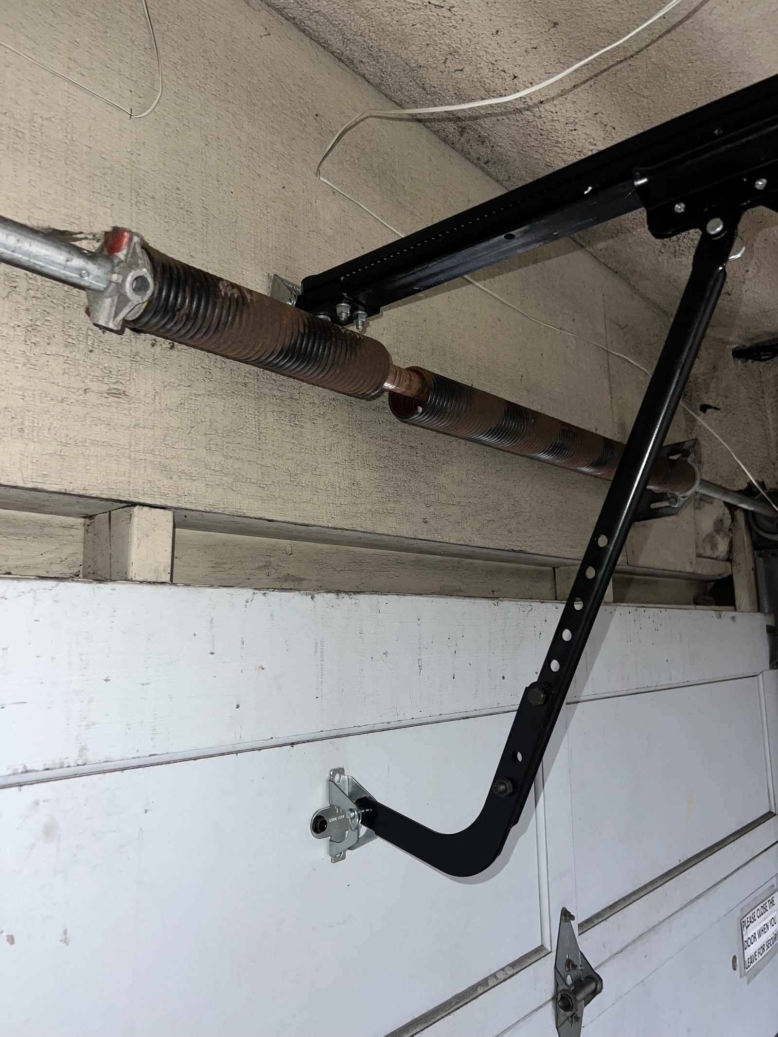 Broken torsion spring on a garage door repaired by Coastside Garage Door in Linda Mar, Pacifica