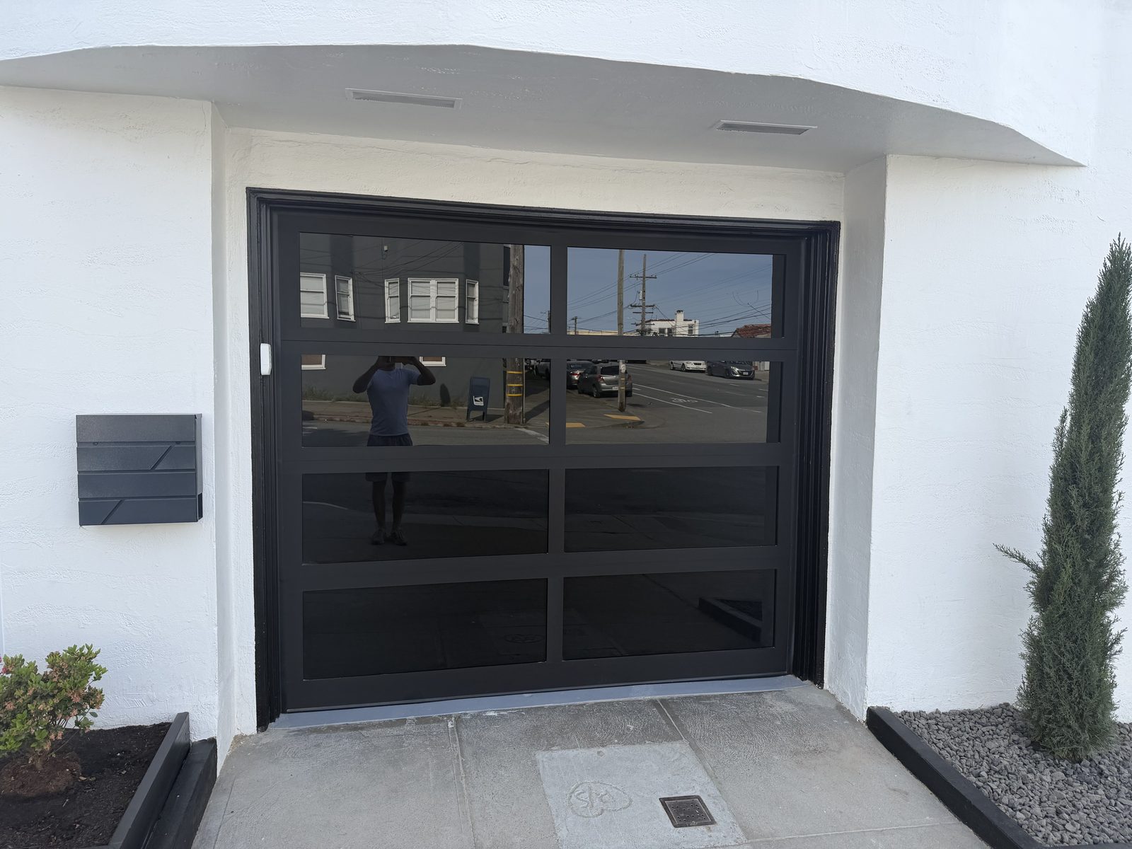 Modern glass panel garage door installed on a home in Daly City, CA