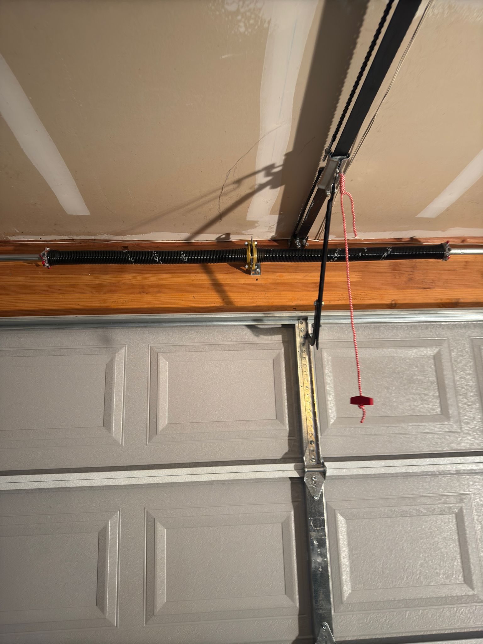 Before and after comparison of garage door spring and roller replacement in Sharp Park, Pacifica